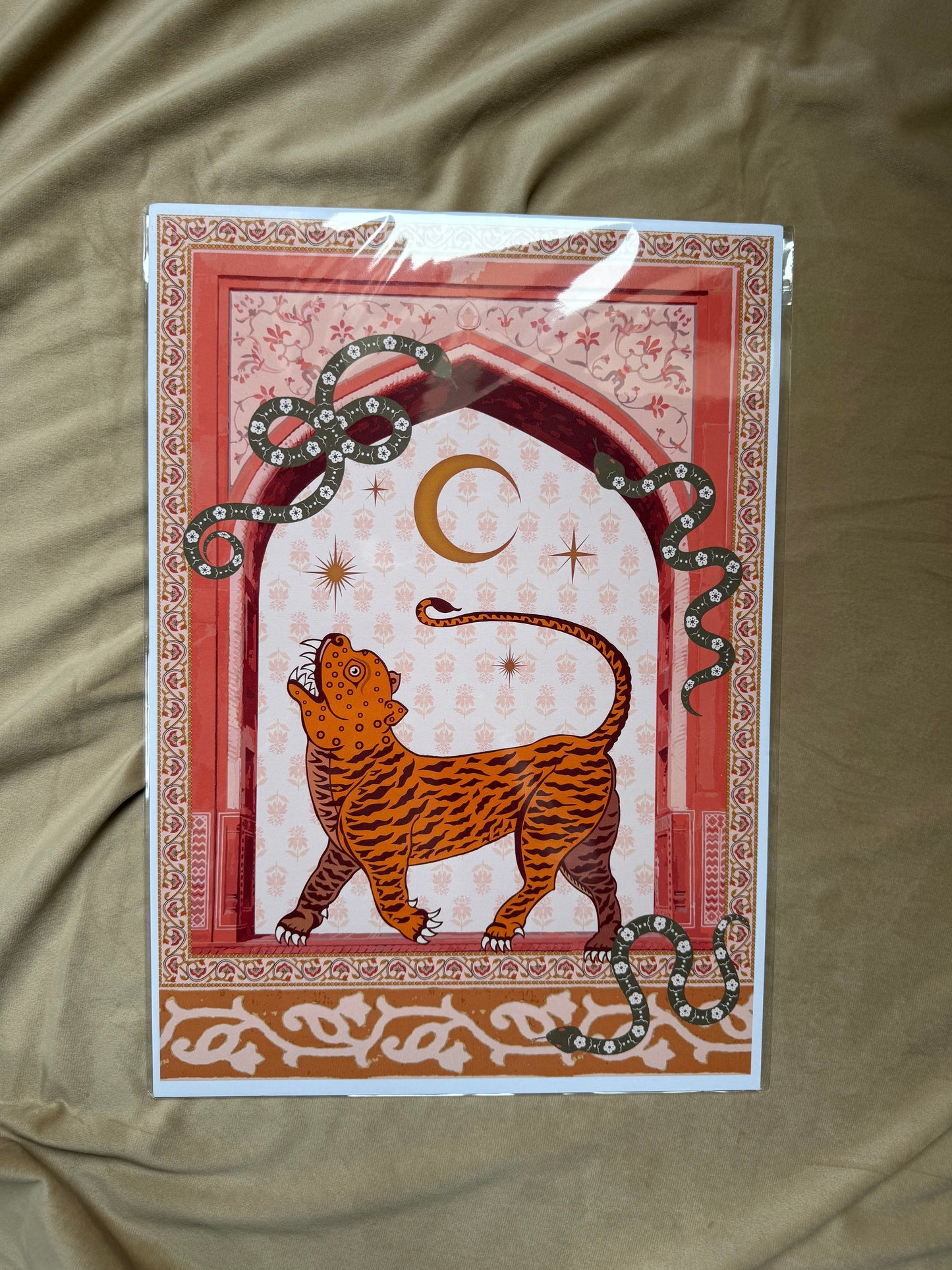 Decorative print with a tiger illustration on a beige fabric background